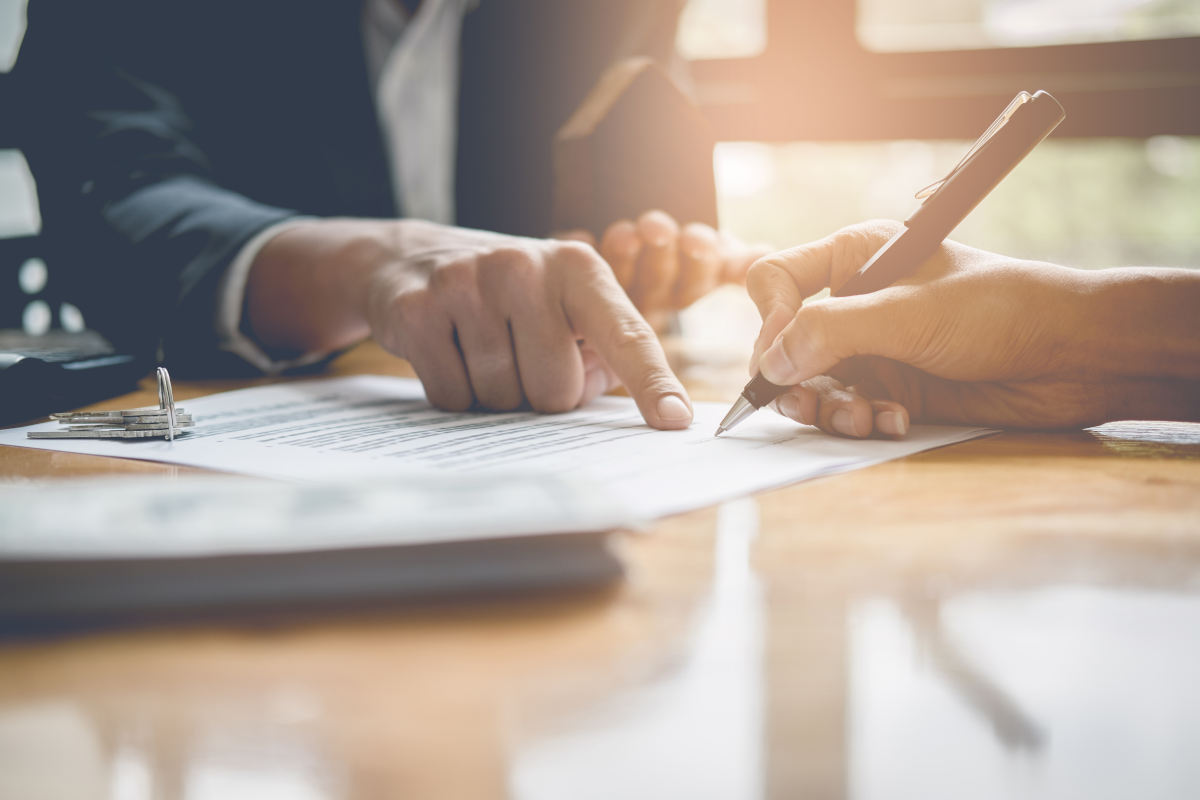 Solicitor and customer signing remortgage paperwork